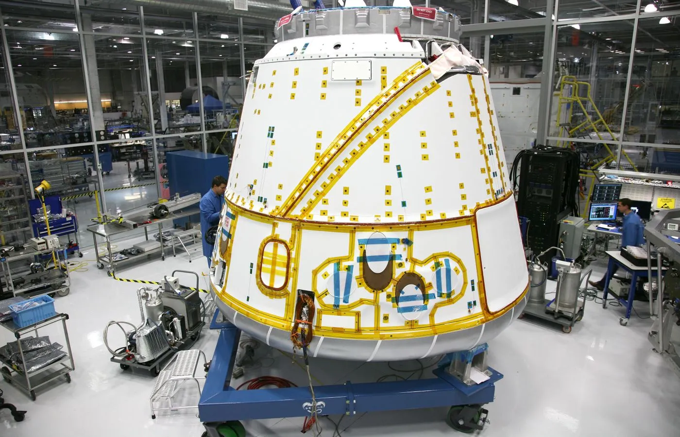 Spacecraft capsule undergoing assembly and verification in a controlled facility