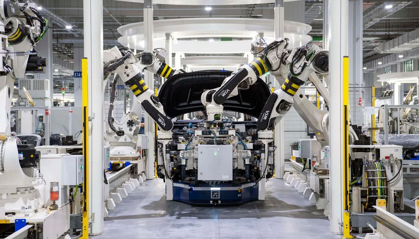 Robotic automotive production line assembling a vehicle