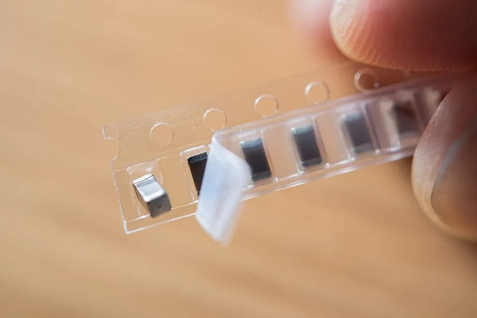 Components in carrier tape with individual pockets visible