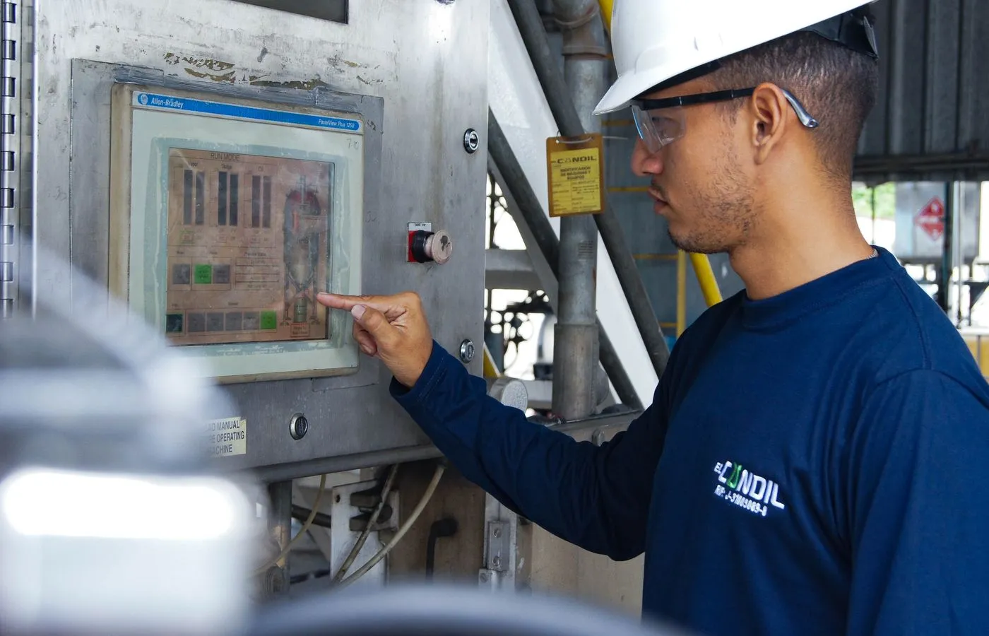 Industrial control engineer operating a machine control panel