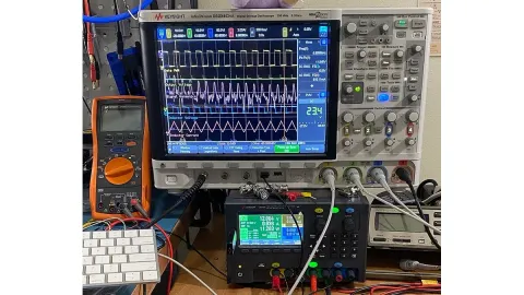 Oscilloscope, digital multimeter and power supply on an electronics laboratory bench