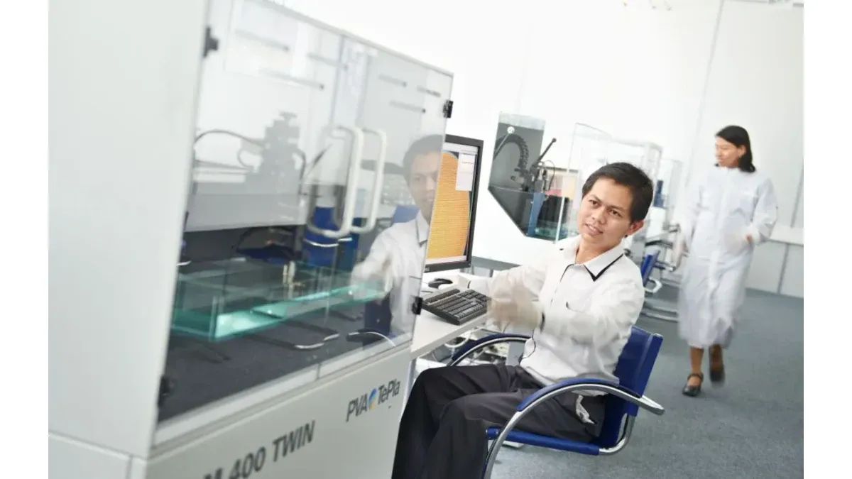 Technician operating an acoustic inspection system in a laboratory