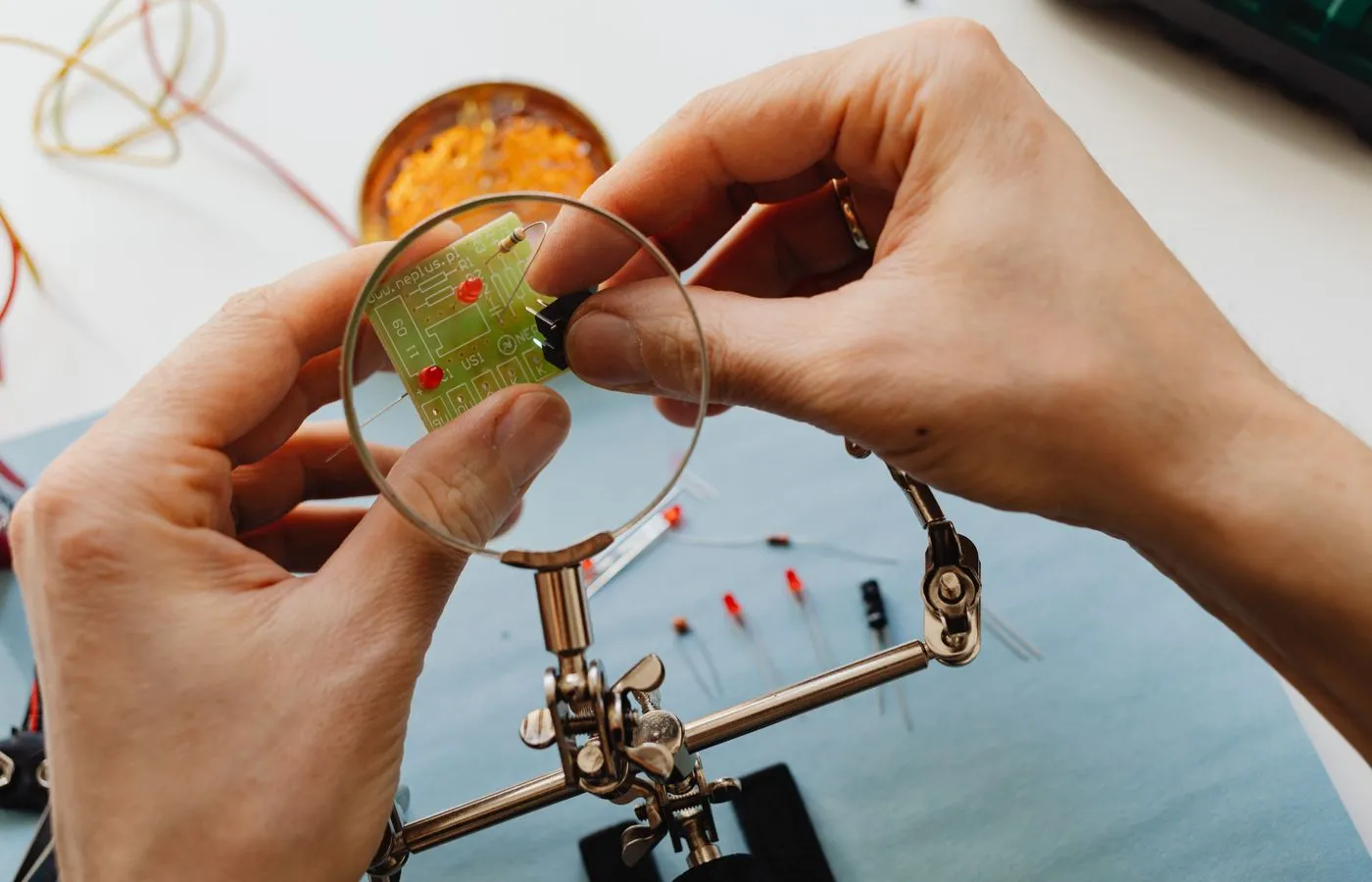 Technician examining an electronic component and circuit board