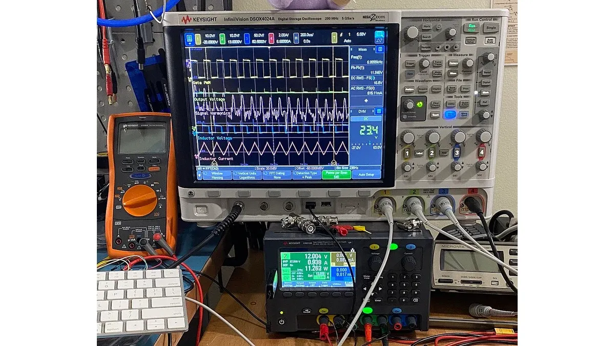 Oscilloscope, digital multimeter and power supply on an electronics laboratory bench