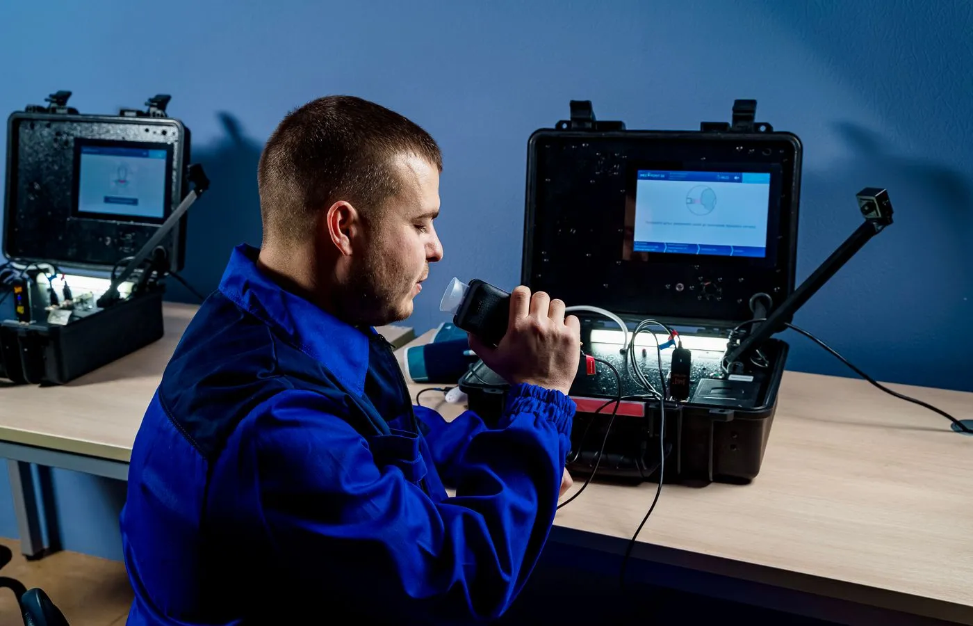 Technician preparing portable electronic diagnostic equipment