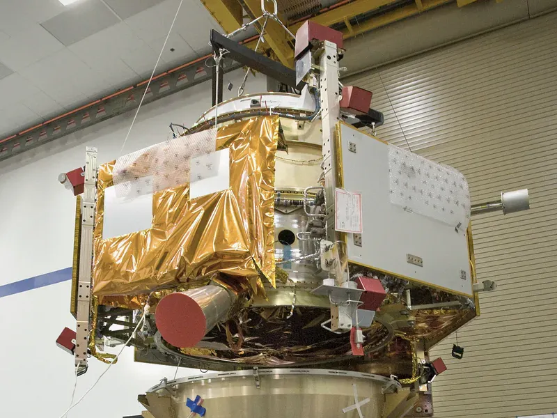 Satellite above Earth illustrating how orbit and mission duration determine total ionizing dose requirements