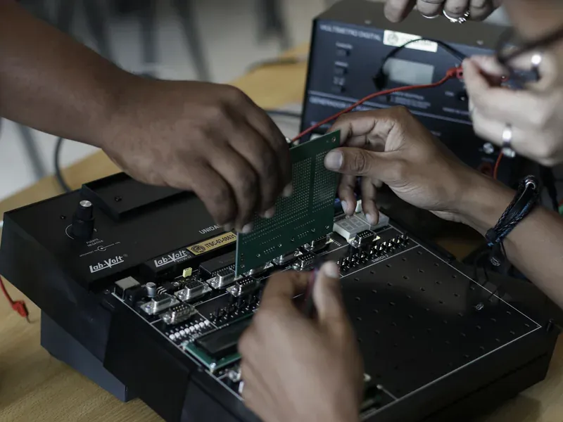 Electronics engineer testing a circuit board during USB controller cross-reference qualification